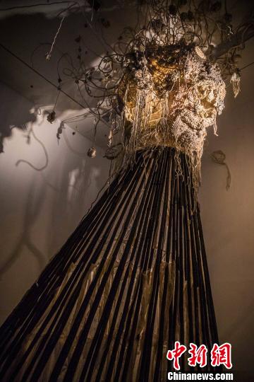邬建安为此次展览创作的《大身体》，用了近千米手织土布以及着蜡丝绸、蜂巢以及染蓝的竹竿，纵贯展场两层的空间 钟欣 摄