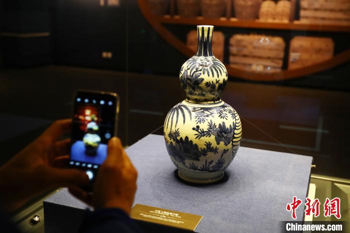 图为参观者用手机拍摄一件青花葫芦瓶。　刘占昆 摄